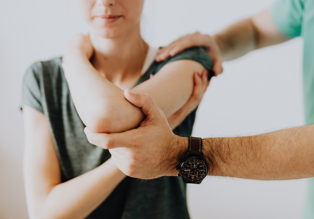 Healthcare professional assessing a patient's arm and joint